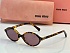Солнцезащитные очки MIU MIU с леопардовой оправой