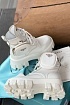 Кожаные женские ботинки Prada белого цвета